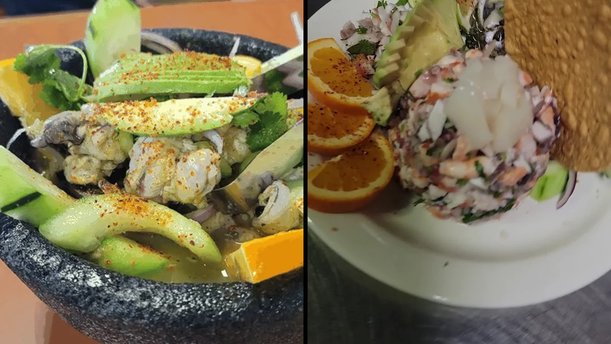 A busy restaurant table with seafood entrées and drinks.