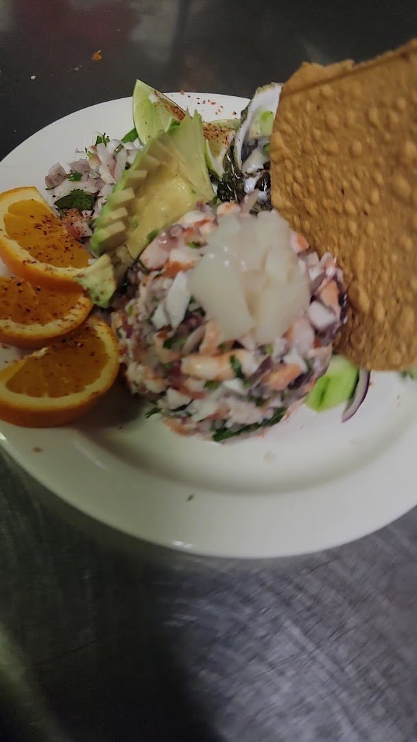 Plates of seafood and rice on a casual table.