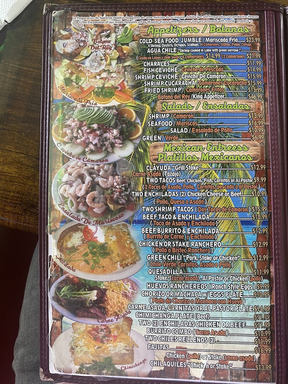 Close-up of a menu with seafood and burrito sections.